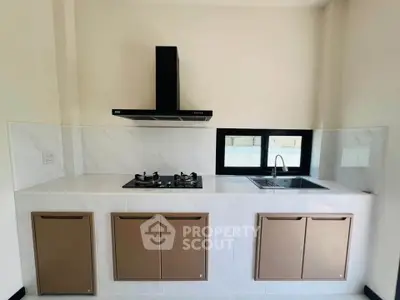 Modern kitchen with sleek gas stove and stylish cabinetry
