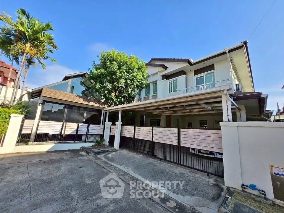 Spacious modern house with large driveway and lush greenery in a serene neighborhood.