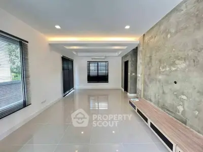 Modern living room with sleek design and large windows for natural light.