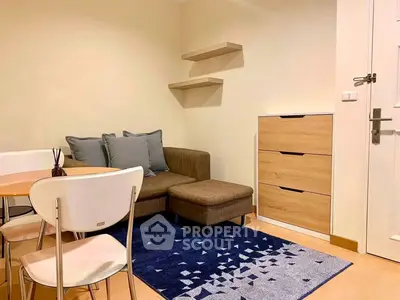 Cozy living room with modern furniture and stylish decor in a compact apartment.