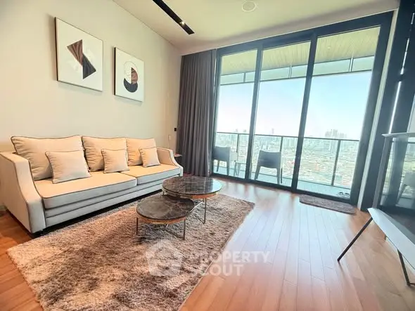Spacious living room with modern decor and stunning city view from large windows.