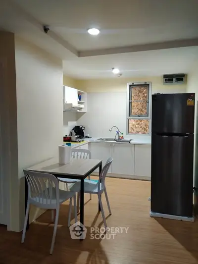 Cozy kitchen with dining area, featuring modern appliances and stylish decor, perfect for urban living.