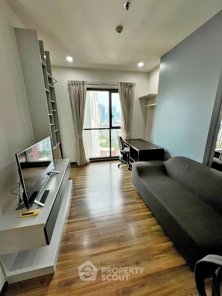 Modern living room with city view, featuring sleek furniture and a cozy atmosphere.
