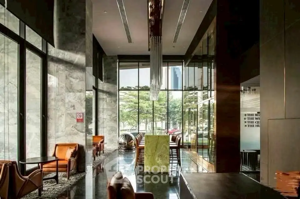Luxurious modern living room with floor-to-ceiling windows and elegant furnishings.