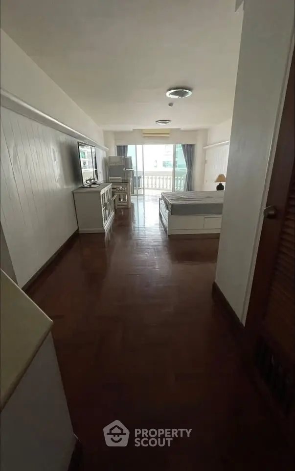 Spacious living room with balcony access and modern decor