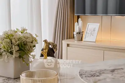 Elegant interior decor with marble table, floral arrangement, and stylish accents in a modern living space.