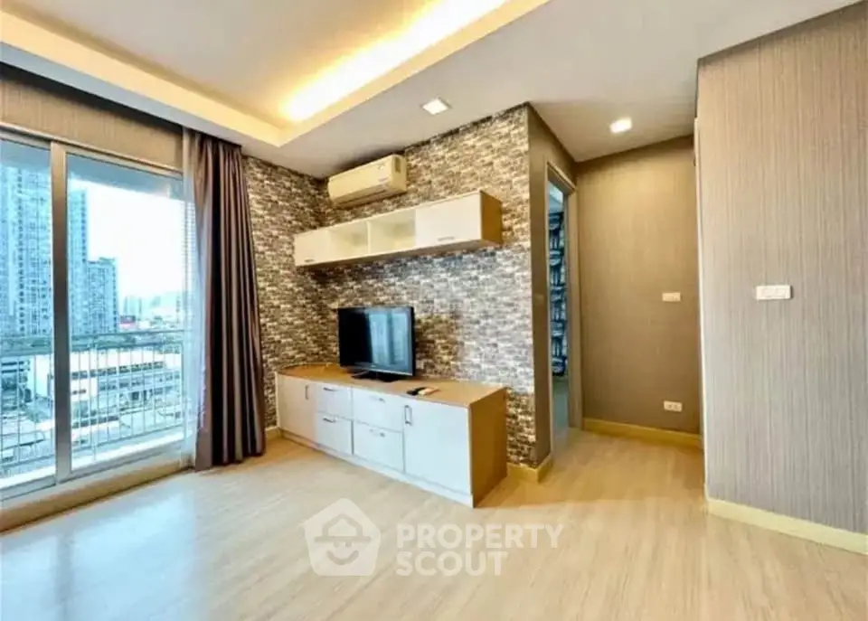 Modern living room with city view, featuring stylish decor and ample natural light.