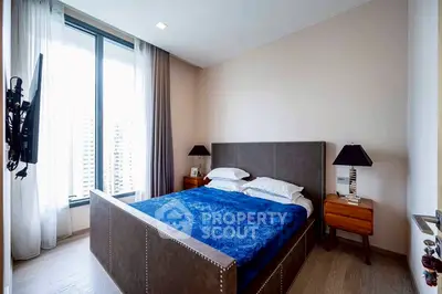 Luxurious bedroom with modern decor and city view, featuring a stylish bed and elegant furnishings.