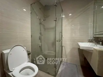 Modern bathroom with glass shower and sleek fixtures, perfect for a contemporary home.