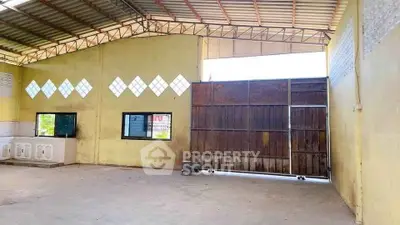 Spacious industrial warehouse with high ceilings and large sliding doors for easy access.