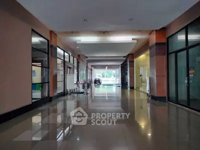 Spacious modern building entrance with glossy floors and glass doors