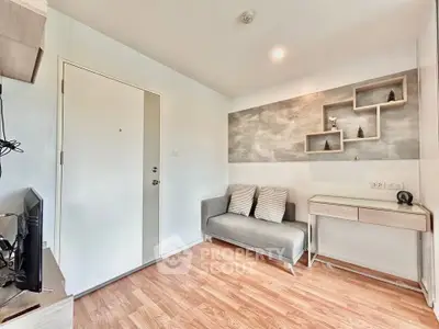 Modern living room with stylish decor and wooden flooring in a cozy apartment.