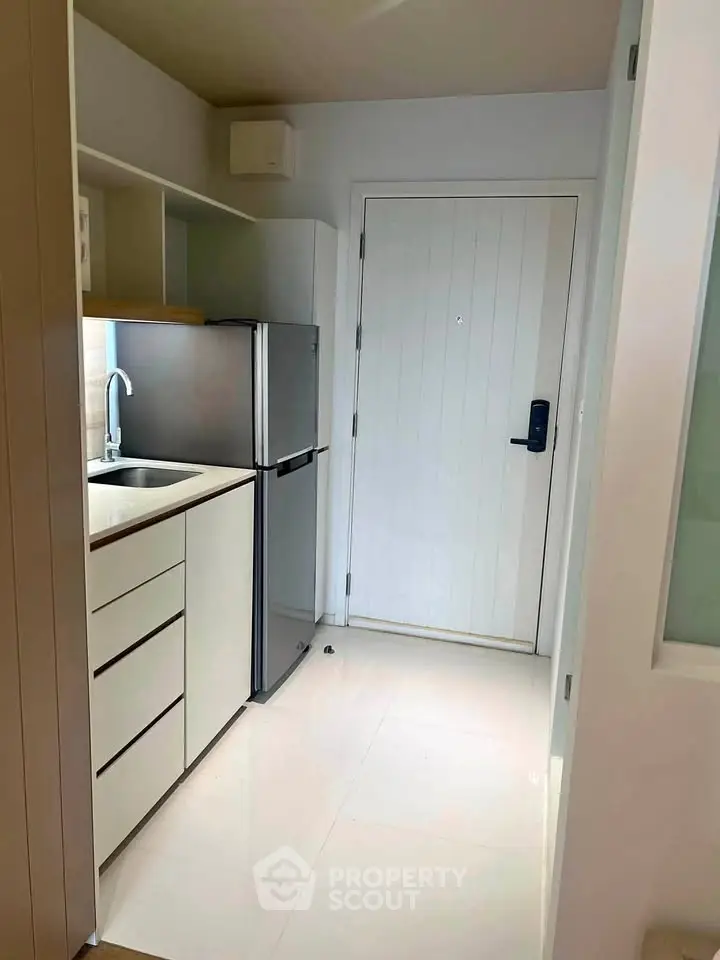 Modern compact kitchen with sleek design and stainless steel appliances