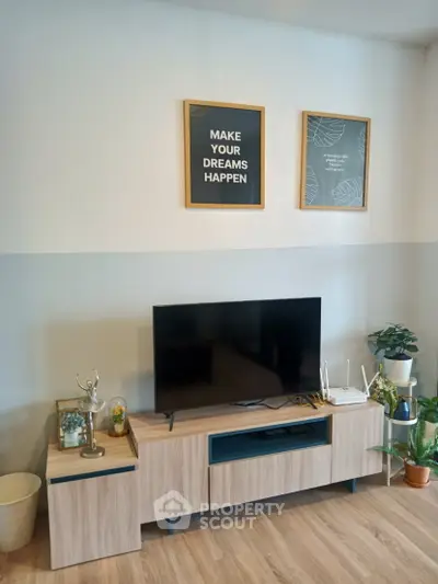 Modern living room with stylish TV stand and motivational wall art