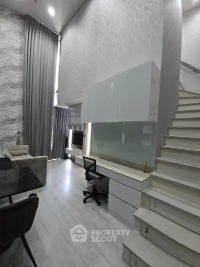 Modern duplex living room with high ceilings and stylish decor