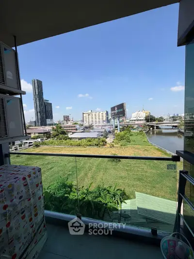 Spacious balcony with stunning cityscape and river view, perfect for relaxation and enjoying urban living.