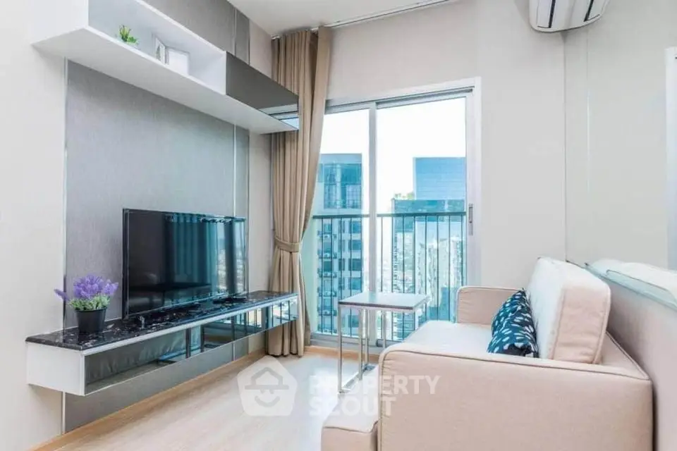 Modern living room with sleek decor and city view balcony in high-rise apartment.