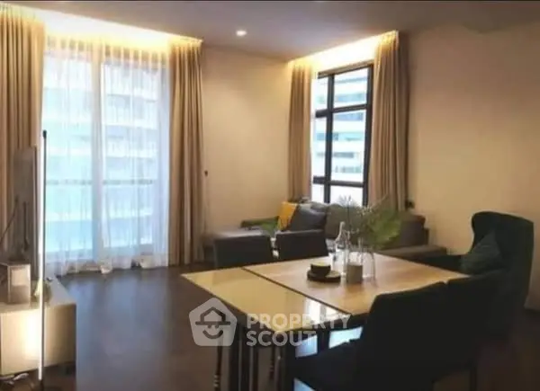 Modern living room with elegant decor and large windows