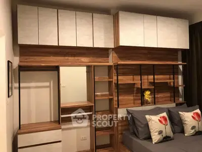 Modern bedroom with stylish wooden shelving and cozy bed setup.