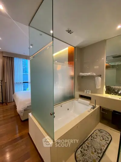 Luxurious modern bathroom with frosted glass partition and elegant fixtures