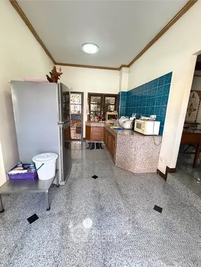 Spacious kitchen with modern appliances and stylish blue tile backsplash