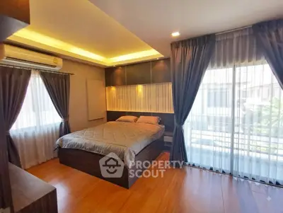 Luxurious bedroom with modern design, large windows, and elegant curtains in a stylish apartment.