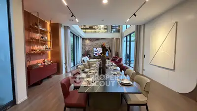 Luxurious dining room with elegant table setting and modern decor in a spacious open layout.