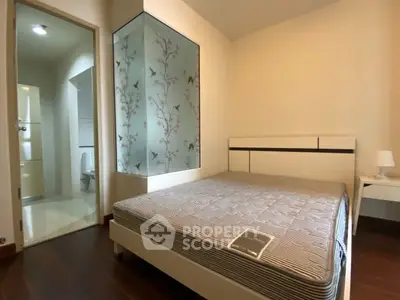 Cozy bedroom with modern design and ensuite bathroom in a stylish apartment.