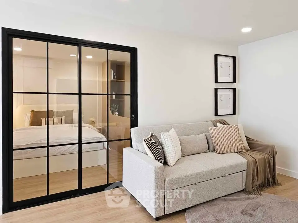 Modern living room with glass partition and cozy sofa in stylish apartment.