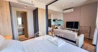 Modern studio apartment with open layout, featuring a cozy bedroom and living area.