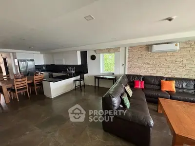 Spacious open-plan living room with modern kitchen and stylish decor