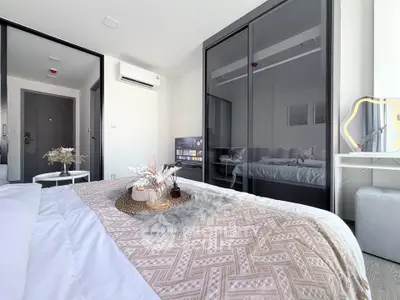 Modern bedroom with stylish decor and large mirrored wardrobe