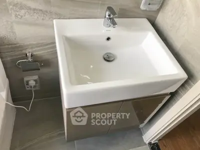 Modern bathroom with sleek sink and elegant tile design, perfect for contemporary living.