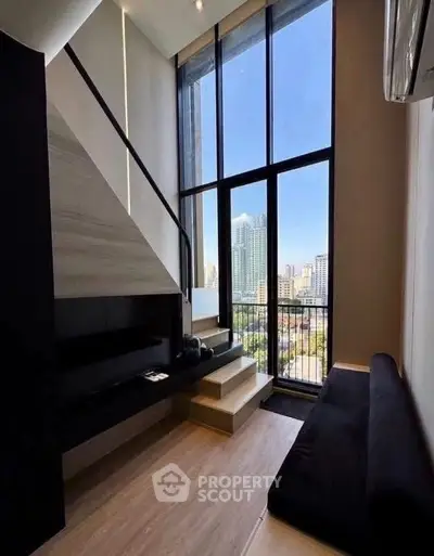 Modern loft apartment with floor-to-ceiling windows and stunning city view