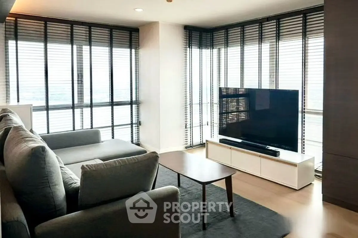 Modern living room with large windows and sleek furniture