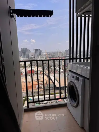 High-rise balcony with city view and washing machine, perfect for urban living.