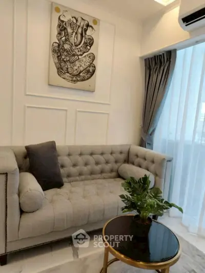 Elegant living room with tufted sofa and modern art decor