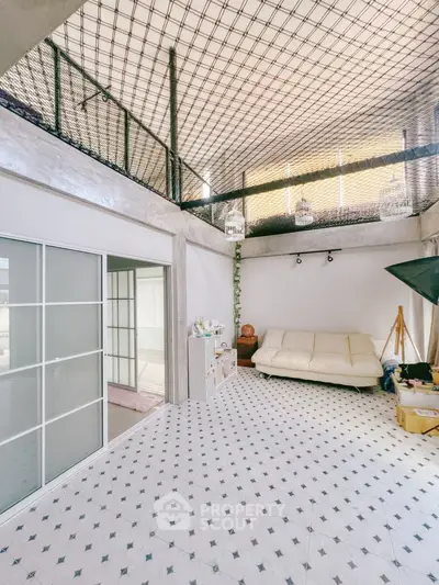Spacious modern living room with high ceiling and stylish decor