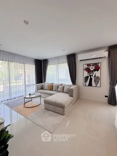 Spacious modern living room with elegant decor and large windows