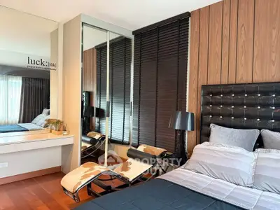 Stylish bedroom with modern decor and mirrored wardrobe