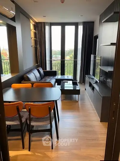 Modern living room with sleek furniture and large windows offering a scenic view.