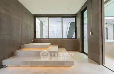 Modern minimalist interior with sleek stone steps and large windows