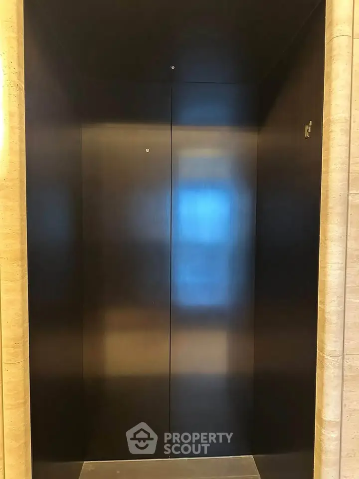 Sleek modern elevator with elegant dark paneling in luxury building