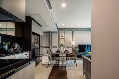 Modern open-plan living and dining area with sleek kitchen design and elegant decor.