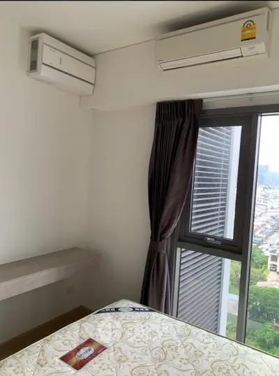 Modern bedroom with air conditioning and city view from window