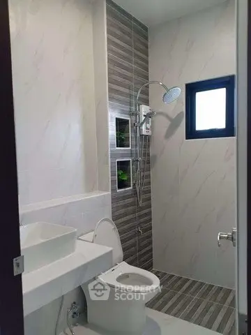 Modern bathroom with sleek shower and stylish tiles in a contemporary home.