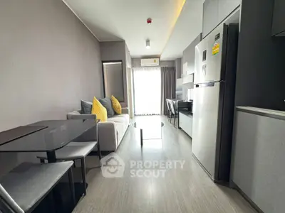 Modern living room with sleek furniture and natural light in a stylish apartment.