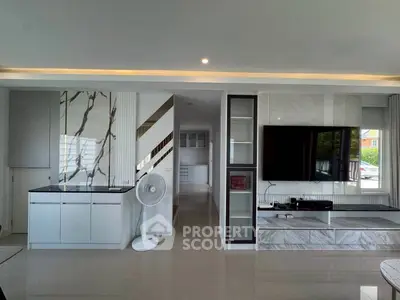 Modern living room with sleek marble accents and large TV setup