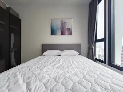 Modern bedroom with large windows and stylish decor in urban apartment