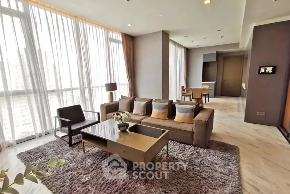 Spacious modern living room with large windows and elegant decor